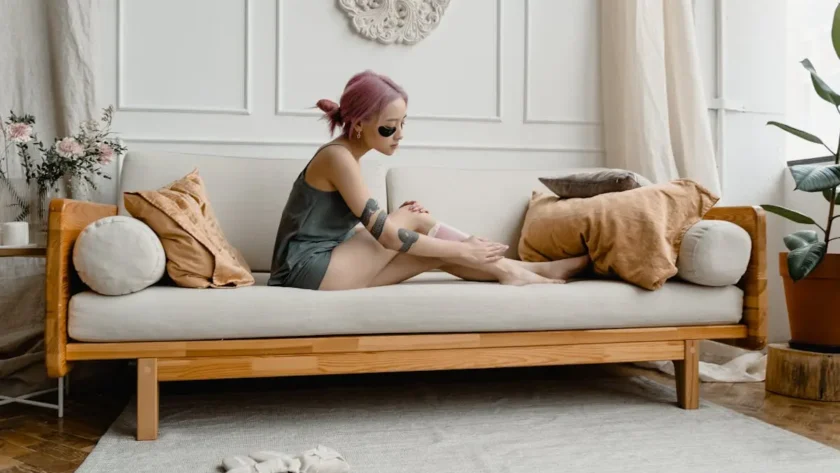 A Woman Waxing her Legs using a Wax Strip